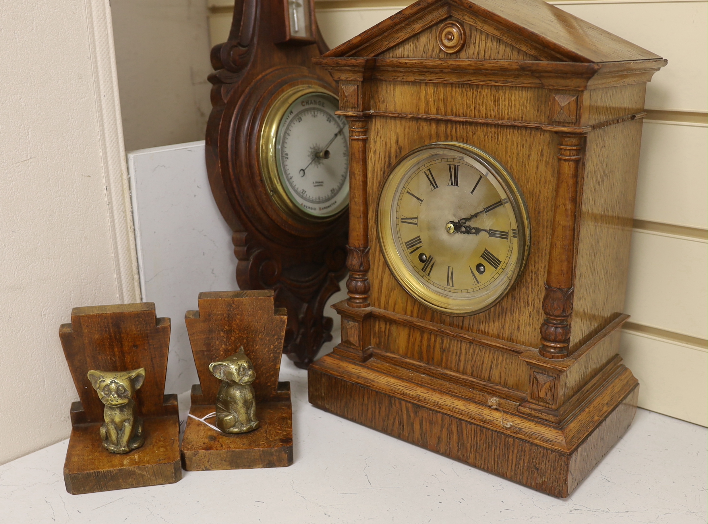 Woodenware including Art Deco bookends, a Black Forest Winterhalder and Hofmeier clock striking on a coiled gong and an aneroid barometer, clock 38cm